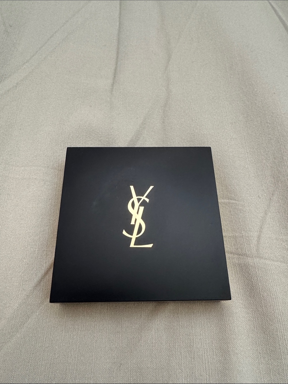 Yves Saint Laurent with Gold Emblem setting compact powder